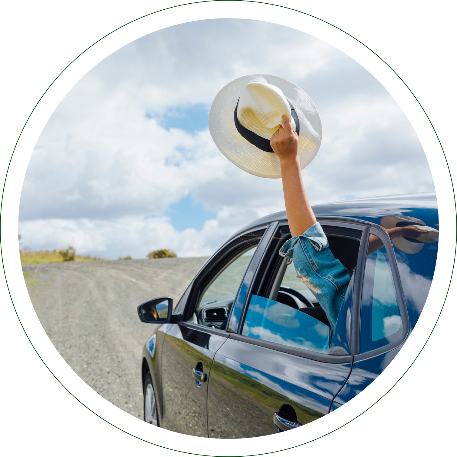 A person in the driver 's seat of a car holding a frisbee.